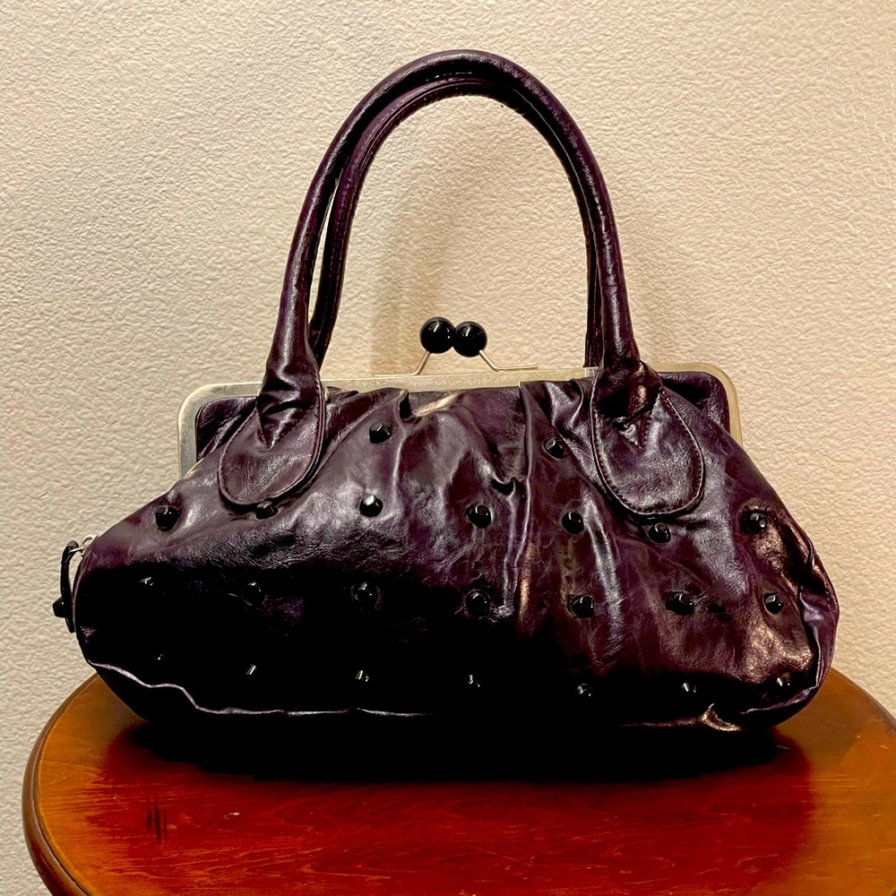 Purple studded frame handbag